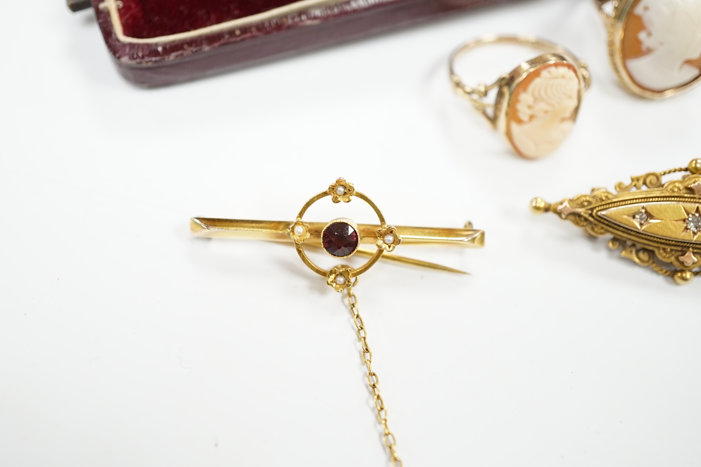 A late Victorian 15ct gold and three stone diamond chip set brooch, 43mm, an early 20th century yellow metal, garnet and seed pearl set bar brooch, two 9ct and oval cameo shell set rings and a yellow metal and cultured p